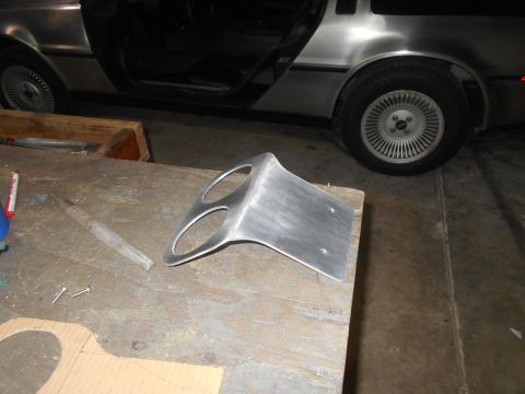1992 Ford Bronco - Custom aluminum gauge pod on workbench, with a DeLorean in the background.
