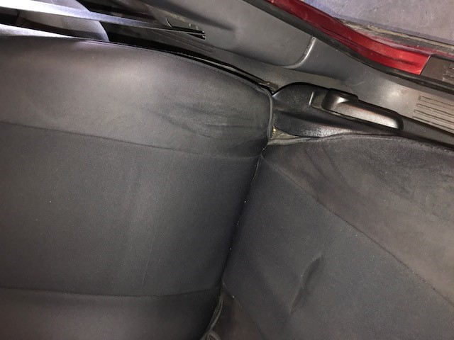 Rear seats and interior trim of a vehicle. A SuperMotors.net watermark is visible