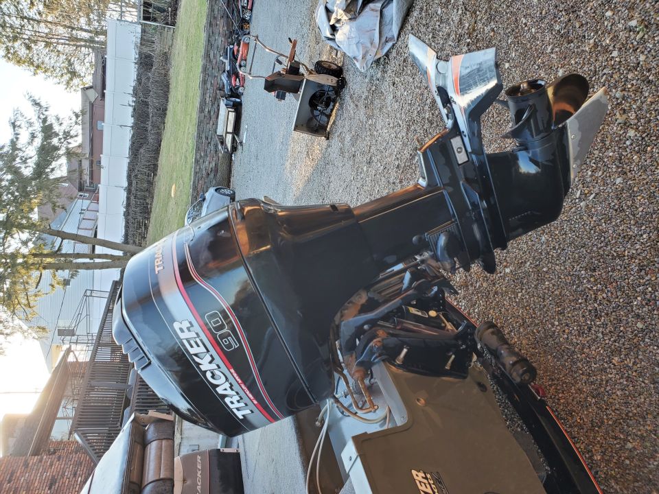 Outboard boat motor with "TRACKER 90" visible on cowl
