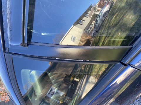 2000 Pontiac Grand Prix - Reflection of a house and another car visible in the windshield of the vehicle.
