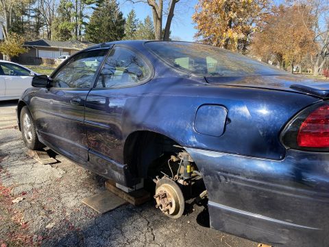 2000 Pontiac Grand Prix coupe, rear wheel removed and car on blocks, blue paint
