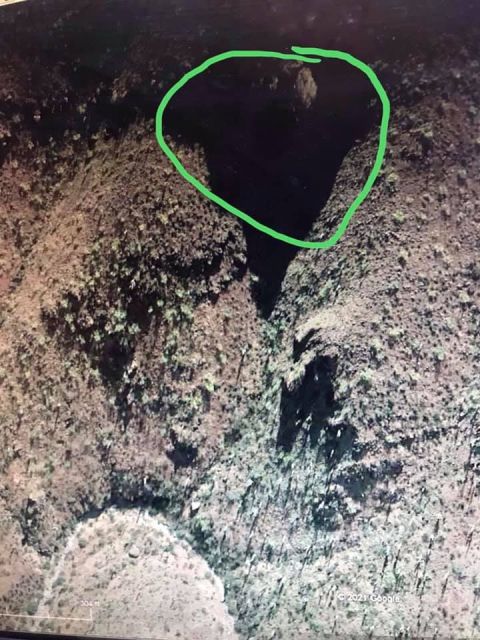 1963 Ford Falcon - Aerial view of a canyon, possibly showing a cave entrance or deep shadow within the terrain.