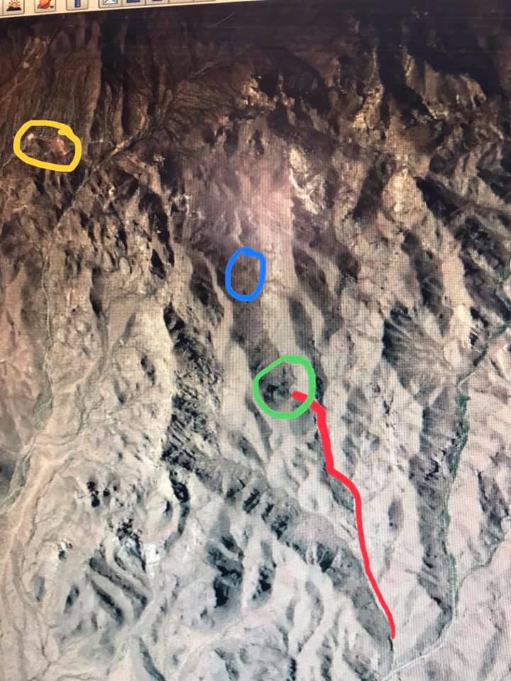 Satellite map showing mountainous terrain with yellow, blue, and green circles and a red line path