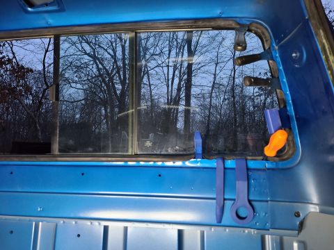 1995 Ford F-150 - Tools are positioned around the rear window of a blue truck cab.