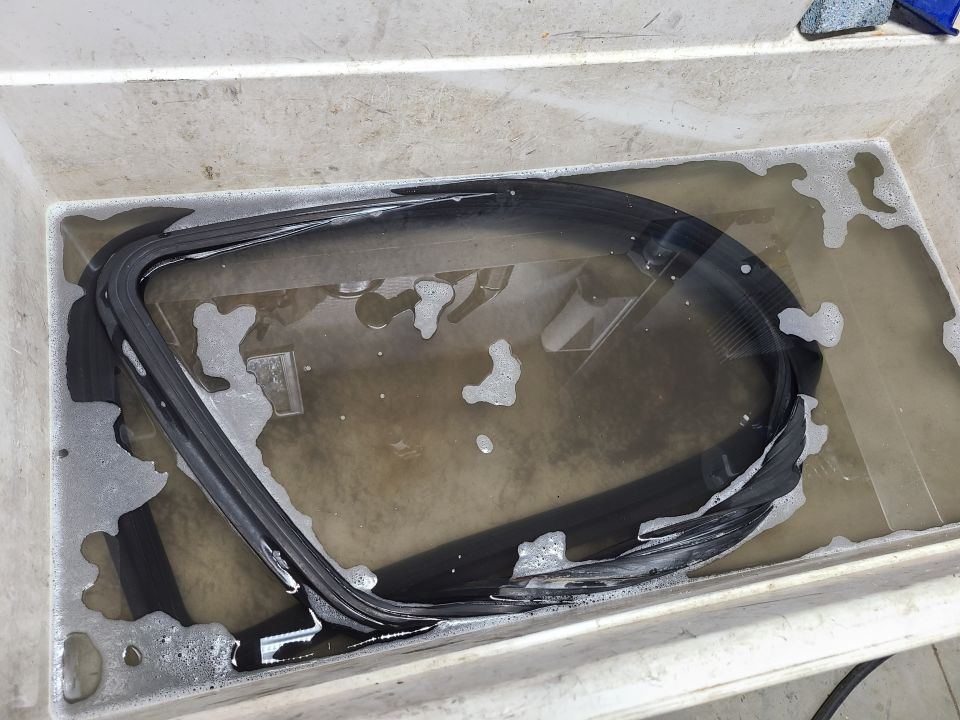 Rubber seal soaking in soapy water inside a tub