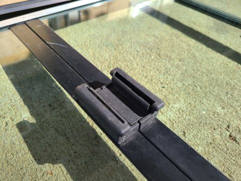 1995 Ford F-150 - Close-up of black window trim and a clip, likely a replacement part.