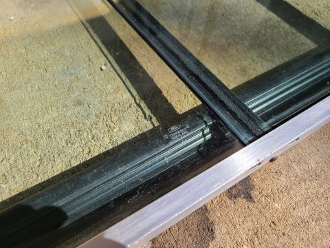 1995 Ford F-150 - Tempered glass panel with Ford branding, likely a vehicle window part.