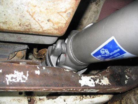 1979 Ford Bronco - Close-up of a driveshaft component, possibly for a 4x4 vehicle, with a manufacturer's sticker.