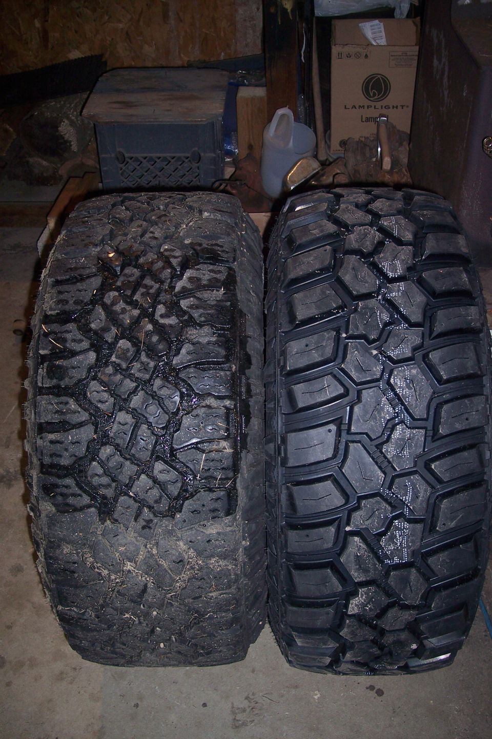Two off-road tires, one used and one new, side-by-side