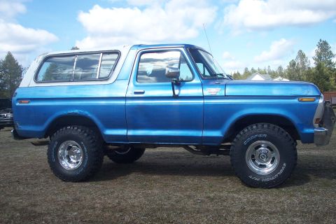 1978 Ford Bronco - This 1978 Ford Bronco, seen from the side, features a two-tone blue and white paint scheme and off-road tires.