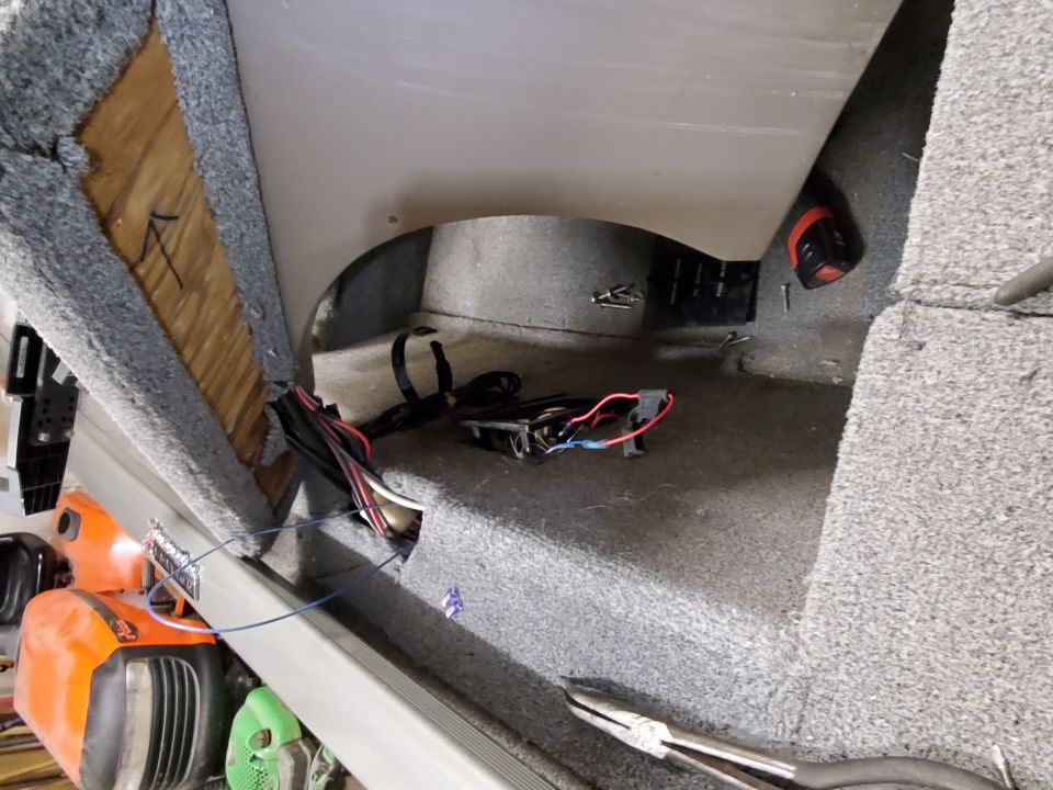 Boat interior showing exposed wiring and carpeted surfaces