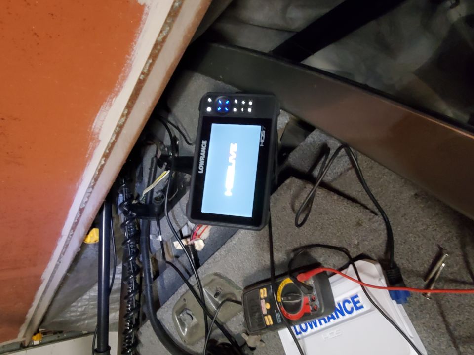Lowrance fish finder and multimeter connected in a boat's interior