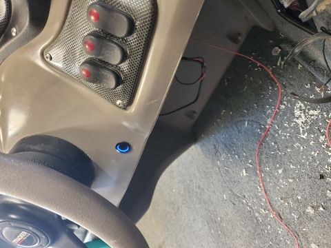 2005 Tracker Tournament - Close-up of a boat's dashboard showing toggle switches and exposed wiring, with debris scattered on the floor.