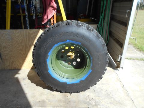 1992 Ford Bronco - A tire and rim assembly is shown, with blue tape applied to the rim's edge.