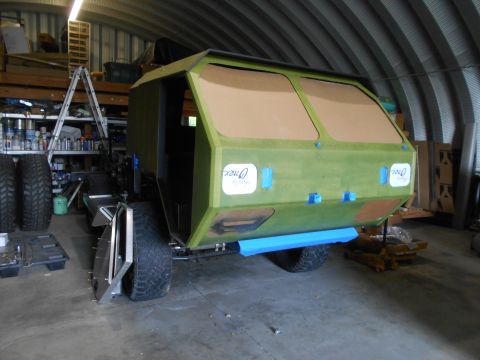 1992 Ford Bronco - Custom off-road vehicle body being built in a workshop, showing large tires and unfinished panels.