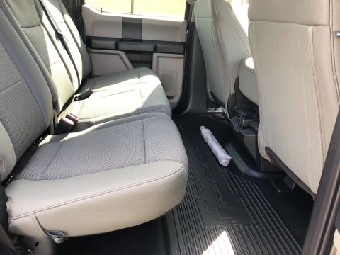 2021 Ford F-250 - Rear interior view of a 2021 Ford F-250, showing seats and floor mats.