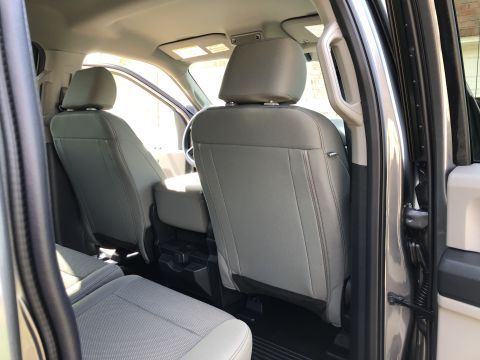 2021 Ford F-250 - The interior of a pickup truck shows the rear seats and door frame.