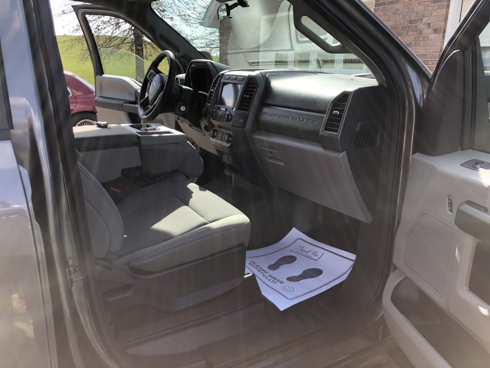 Interior view of a gray pickup truck with a large touchscreen and "SUPER DUTY" badging