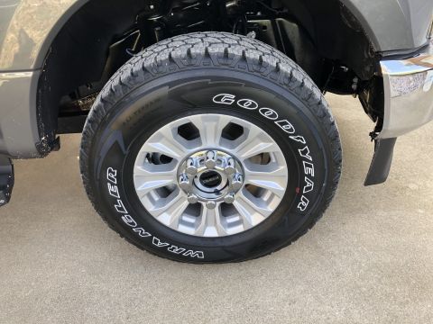 2021 Ford F-250 - Close-up of a gray Ford F-250's front wheel and tire, showing the tread and alloy rim.