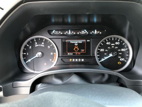 2021 Ford F-250 - The dashboard shows the passenger door is open, with the odometer reading 28.4 miles.