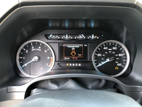 2021 Ford F-250 - Dashboard gauges display mileage and a warning that the passenger door is ajar.