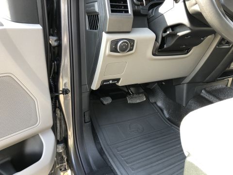 2021 Ford F-250 - Driver's side footwell and lower dashboard of a 2021 Ford F-250, rubber floor mats.