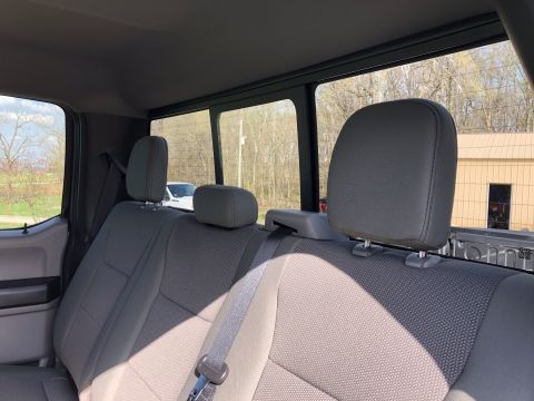 2021 Ford F-250 - Interior view of pickup truck rear seats, with another vehicle seen outside.