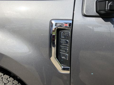 2021 Ford F-250 - The side badge on this Ford truck clearly shows 'STX' and 'Super Duty'.