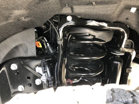 2021 Ford F-250 - Close-up view of the front suspension system, showing the coil spring and shock absorber.
