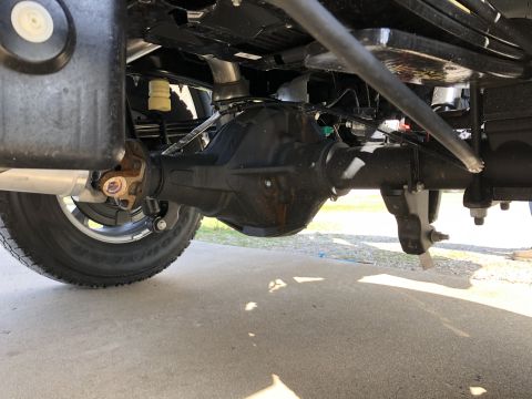 2021 Ford F-250 - Close-up of the rear axle assembly and suspension parts on a truck.