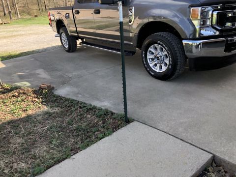 2021 Ford F-250 - Gray Ford Super Duty truck parked on a concrete driveway.