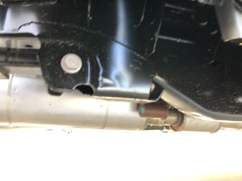 2021 Ford F-250 - Close-up of the undercarriage, showing the exhaust pipe and frame structure.