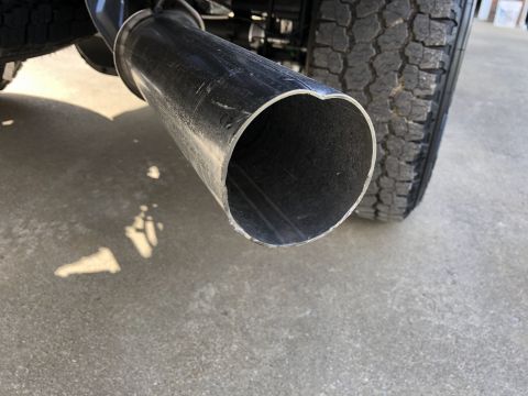 2021 Ford F-250 - Exhaust pipe and tire detail from a truck.