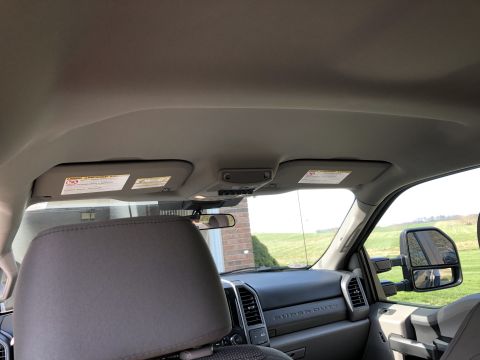 2021 Ford F-250 - Interior view of a truck, focusing on the dashboard and side mirror, with a glimpse of the exterior.