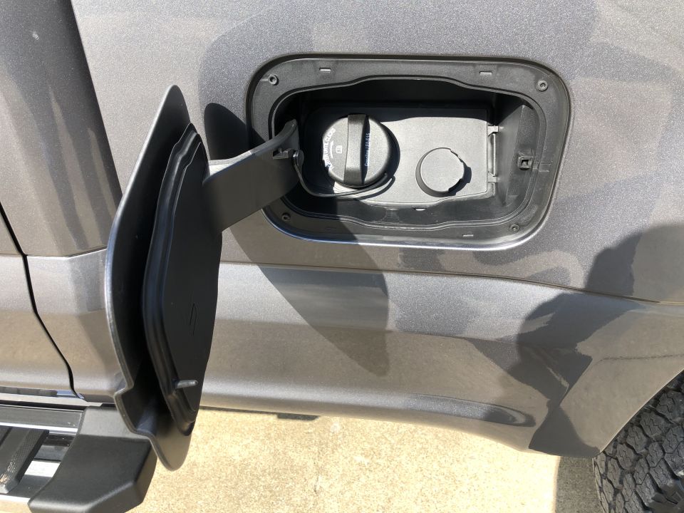 2021 Ford F-250 fuel filler door open showing cap and recess