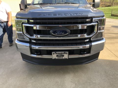 2021 Ford F-250 - The front grille of a Ford Super Duty truck is shown, with a license plate from Sternberg Ford in Dale, IN.