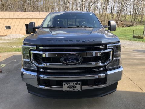 2021 Ford F-250 - Front view of a gray Ford Super Duty truck with a chrome grille and "SUPER DUTY" badging on the hood.