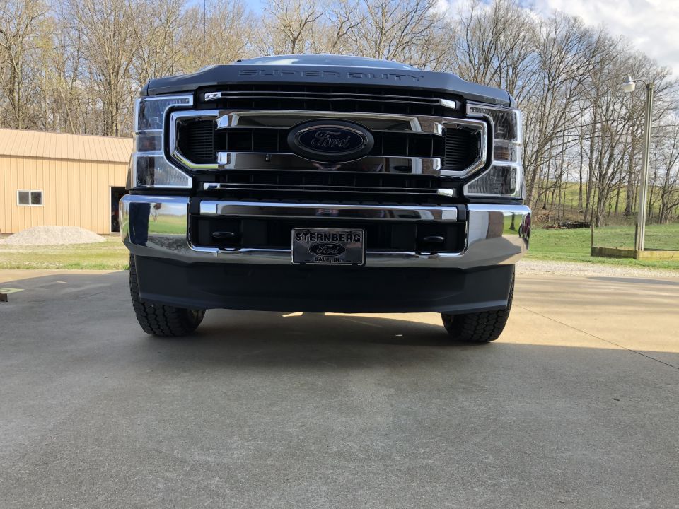 Front view of a black 2021 Ford F-250 Super Duty truck with chrome grille and Ford logo