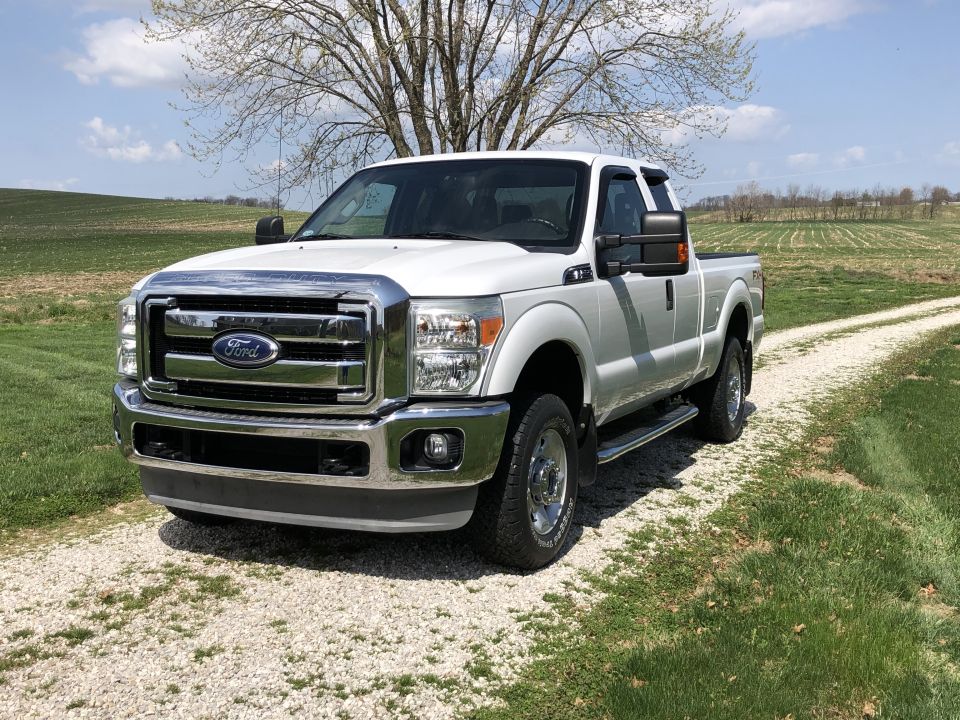2011 Ford F-250 Super Duty pickup truck parked on a gravel driveway