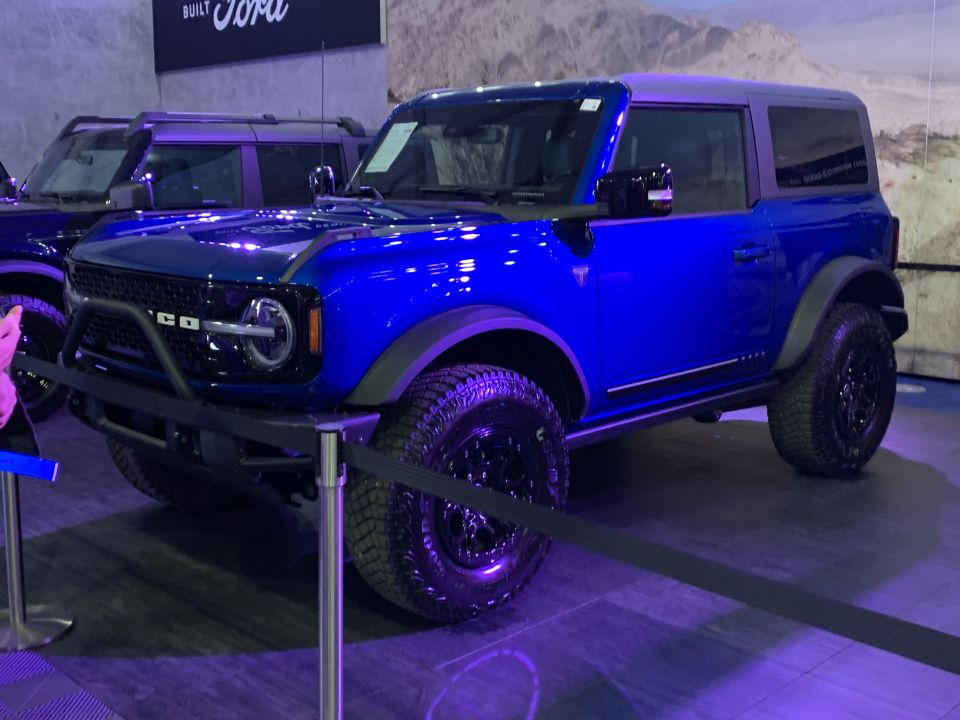 Blue 2021 Ford Bronco two-door parked indoors with another Bronco behind it
