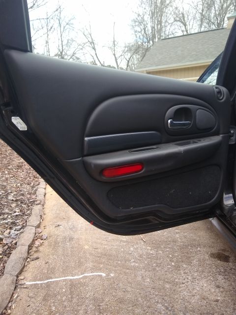 2002 Chrysler 300M - The interior of a car door is shown, with the door open to reveal the outside.