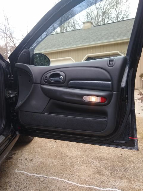 2002 Chrysler 300M - Close-up of the interior door panel, showing the handle, speaker, and door light.