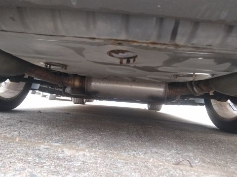 2002 Chrysler 300M - Underside view of a car's exhaust system, showing the muffler and pipes.