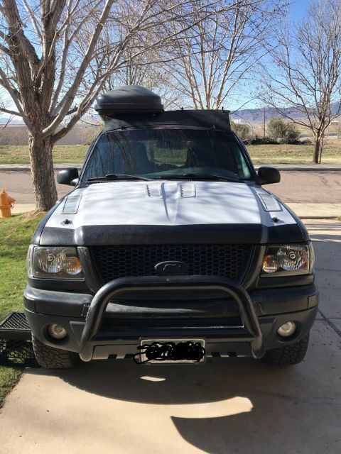 2000 Ford Explorer - Front view of a 2000 Ford Ranger pickup truck equipped with a bull bar and a cargo box on the roof.