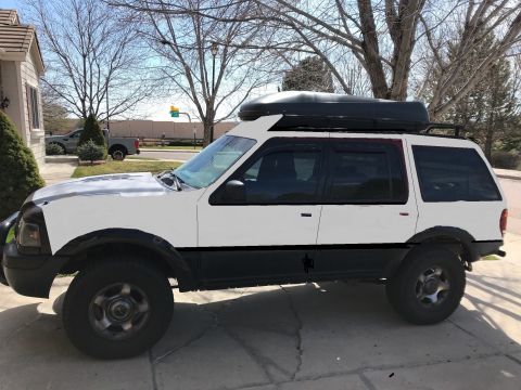 2000 Ford Explorer - 2000 Ford Explorer parked in a driveway with a roof cargo box and roof rack.