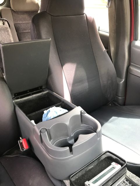 2000 Ford Explorer - View of the center console and seats inside a vehicle, showing cup holders and storage.