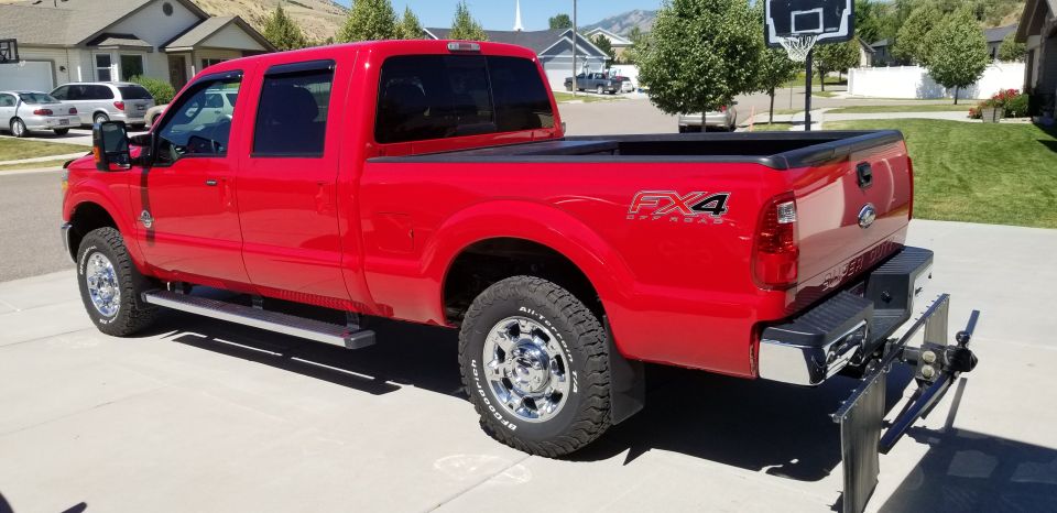 Red 2012 Ford F-250 pickup truck, 3q-front view, with FX4 badging