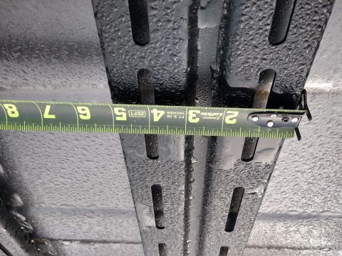 2018 Toyota 4Runner - A tape measure is used to check the dimensions of a wet, slotted roof rack component.
