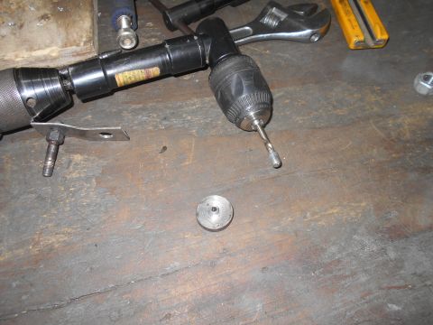 1992 Ford Bronco - Tools and parts are laid out on a wooden surface, suggesting a repair or assembly process.