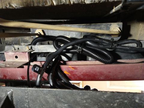 1996 Ford Bronco - Underside view of vehicle wiring and hoses, with some identifying text visible on the tubing.